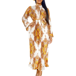 Close-up detail of pleated chiffon texture and vintage paisley print on long sleeve dress