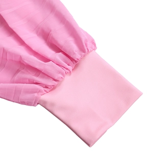 Close-up of pink chiffon pleated top sleeve cuff with elastic ribbed texture details