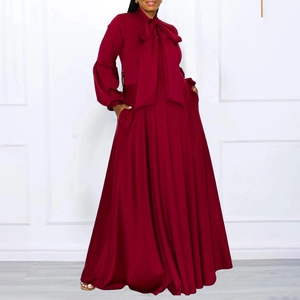 Detail view of the elegant wine red maxi dress featuring bow tie neck and lantern sleeves