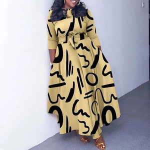 Close-up of yellow dress with black abstract geometric print and waist tie detail