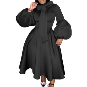 Detail of the oversized lantern sleeves and large bow neckline on a black evening gown