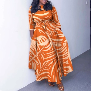 Detail of tropical leaf print long dress with self-tie waist belt and elegant flared skirt