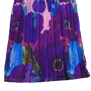 Detail view of pink chiffon pleated pants with vibrant purple and blue floral prints