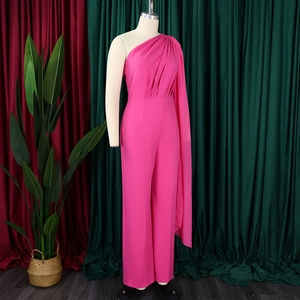 Detail of fuchsia one-shoulder jumpsuit with pleated cape and high waist design