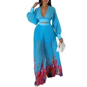 Detail of light blue V-neck pleated crop top and matching floral print wide-leg trousers