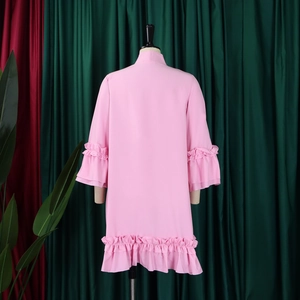 Detail of pink flare sleeves and double-layered ruffles on back of A-line dress