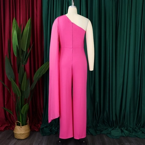 Detail of hot pink one-shoulder jumpsuit featuring an elegant floor-length cape sleeve