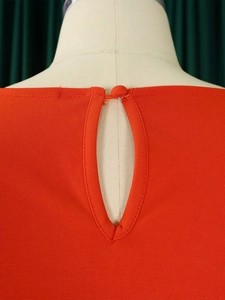 Close-up of red two-piece set featuring back keyhole design with fabric button closure