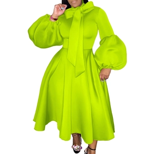 Detail of lime green maxi dress featuring a large bow neckline and puff lantern sleeves
