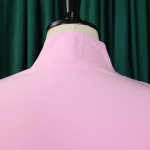 Detail shot of the pink dress collar and fabric texture on a mannequin stand