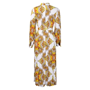 Detail of bohemian floral print maxi dress featuring elegant pleated texture and waist belt