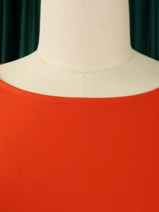 Detail of the high-quality round neckline and fine stitching on the red elegant top