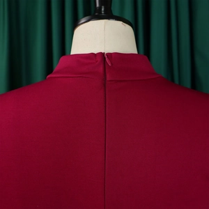 Detail of high collar and invisible zipper closure on wine red puff sleeve maxi dress