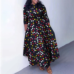 Detail of elegant black midi dress with colorful polka dots and a waist tie-up belt