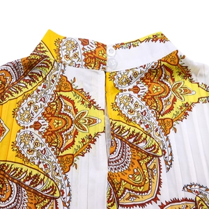 Detail of high collar and back button closure on orange paisley pleated dress