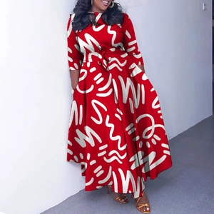 Detail of red maxi dress featuring white abstract scribble print and waist tie-up belt