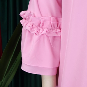 Close-up of elegant candy pink chiffon sleeve with double-layered ruffle detailing