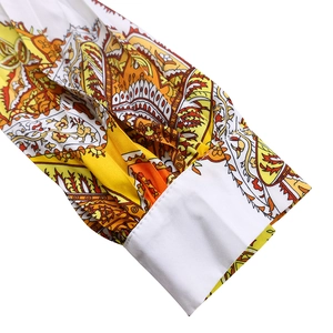Detailed close-up of paisley pattern sleeve with white cuff on long sleeve dress