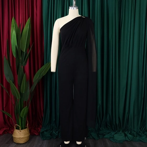Detail of elegant black one-shoulder jumpsuit with a flowing cape sleeve and wide-leg cut