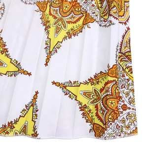 Detail view of pleated hem with yellow paisley print on white fabric for women dress