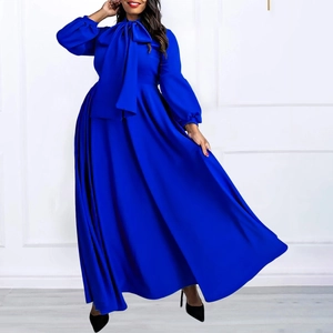 Detail of royal blue lantern sleeves and high-waisted bow tie on a maxi dress