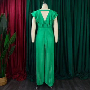 Détail de la combinaison vert émeraude avec décolleté en V et volants plissés