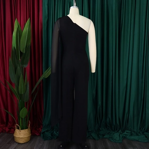 Rear view of black one-shoulder jumpsuit with a flowing sheer tulle cape and wide legs