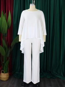 Detail view of white two-piece set featuring irregular hem top and wide leg trousers