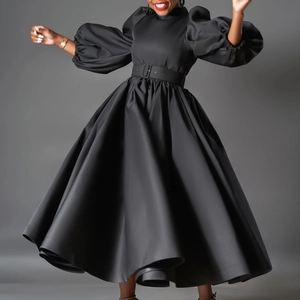 Detail of elegant black satin plus size dress with puff sleeves and flared pleated hem