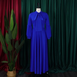 Detail of royal blue maxi dress featuring a bow tie neckline and elegant puff sleeves