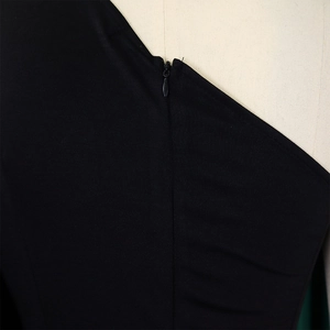 Close-up of invisible zipper closure on the back of this elegant black one shoulder jumpsuit