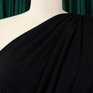 Detail of elegant black one-shoulder dress with sophisticated pleat work on the shoulder