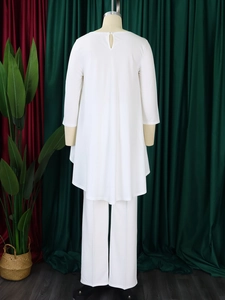 Detail showing the elegant back drop opening and asymmetric hem of the white two-piece set