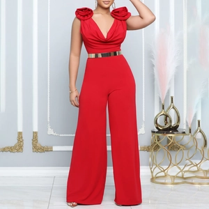 Dettaglio tuta rossa elegante con rosa 3D sullo scollo a V e cintura dorata