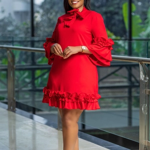 Detail of red tiered bell sleeves and bow neckline on a solid color A-line dress