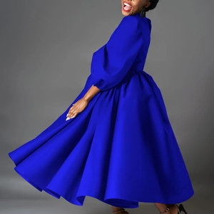 Detail of royal blue high neck maxi dress with lantern sleeves and flowing skirt movement