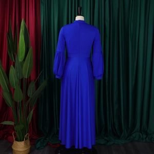 Detail of royal blue maxi dress with puffy sleeves and back zipper closure on mannequin