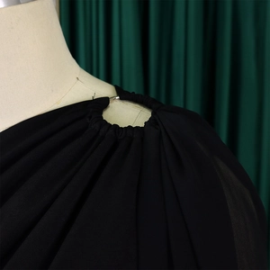 Close-up of the metal ring buckle and pleated detail on this elegant black jumpsuit