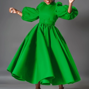 Detail of bright green long sleeve dress featuring puffy lantern sleeves and a belted waist