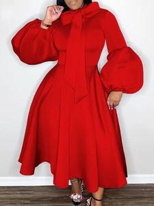Elegant red plus size cocktail dress with puff sleeves and large bow neck tie detail