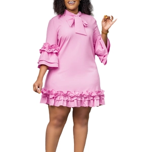 Detail of pink mini dress featuring a bow tie neckline and layered ruffle bell sleeves
