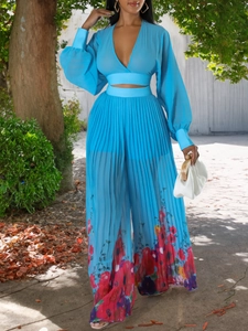 Lightweight blue two-piece chiffon set with V-neck cropped top and floral wide-leg pants