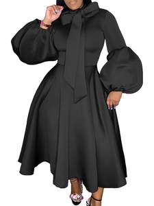 Black plus size party dress with puff sleeves, pussy-bow neck, and large flared skirt
