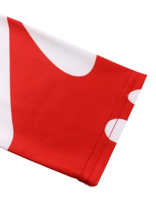 Detailed close-up of double-stitched sleeve cuff on elegant red and white floral dress
