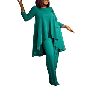 Detail of dark green two-piece set featuring irregular hem top and wide leg trousers