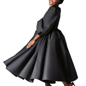 Detail of elegant black dress with puff sleeves and voluminous pleated skirt silhouette