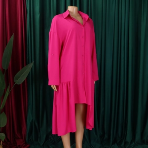 Detail of fuchsia long sleeve shirt dress with asymmetric hem and ruffle trim details