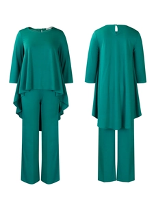 Detail showing teal two-piece set with asymmetrical high-low hem and wide-leg trousers