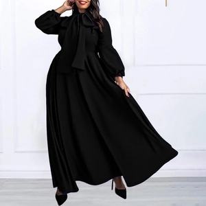Detail of elegant black long dress with bow tie neckline and high waist design