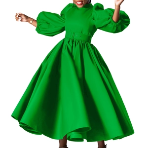 Detail of elegant lantern sleeves and buckled waist belt on a bright green dress